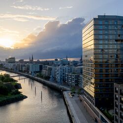 Exterior view of the Roots skyscraper in HafenCity at dusk