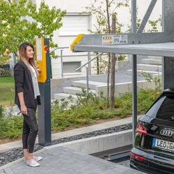 A woman operates a car parking system
