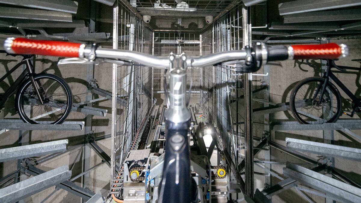 The bicycle is secured in a rail within the parking system