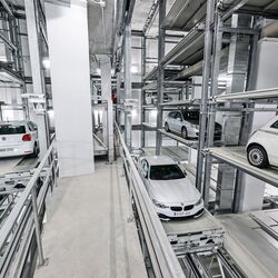 The cars are parked in a rack system