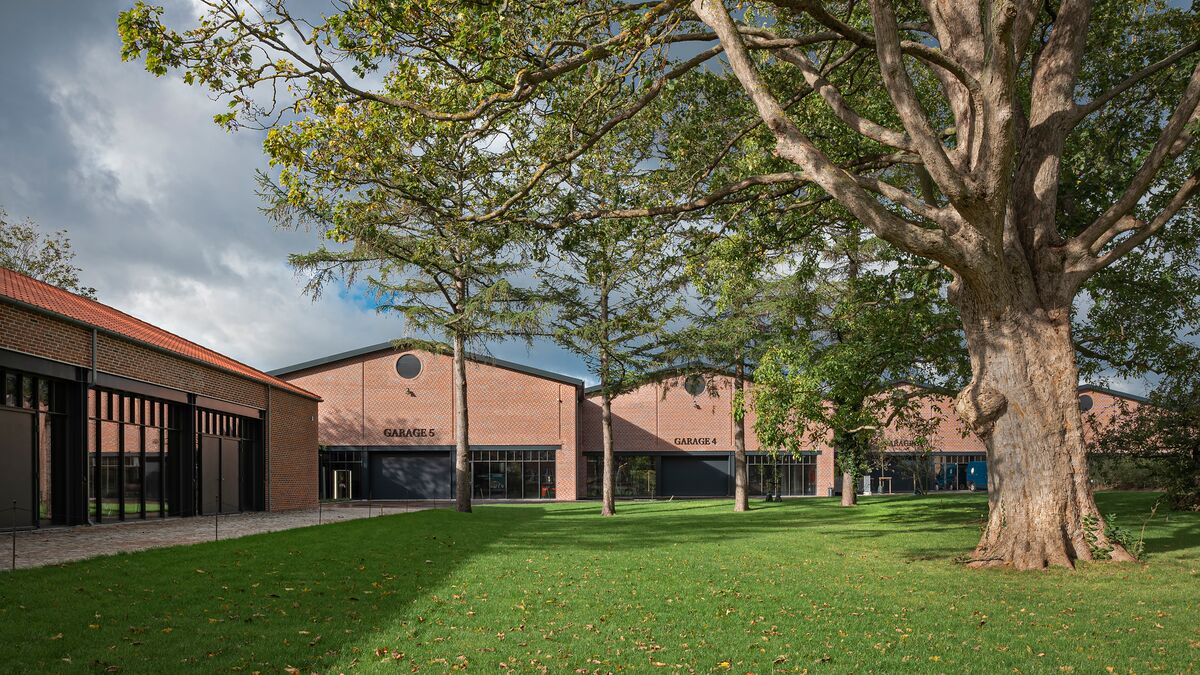 A meadow with museum halls in the background