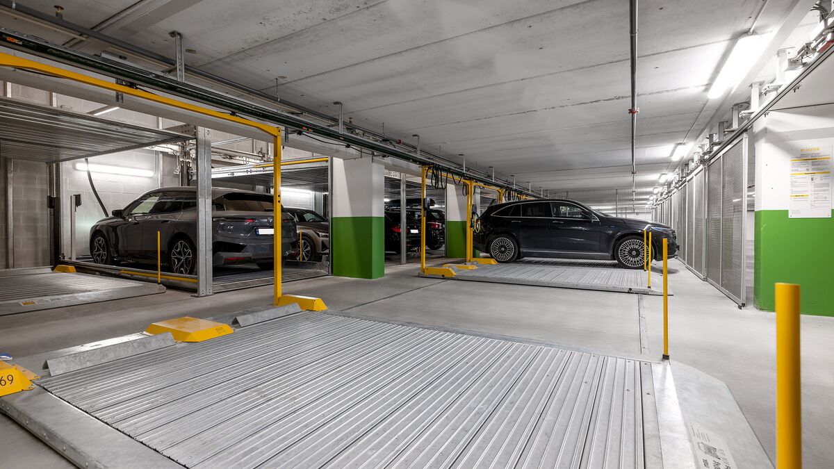 Several cars are parked on the parking platform in an underground garage.