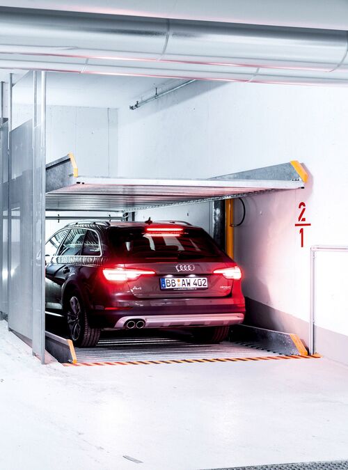 Front view of the parking system, showing a car parked on a parking platform