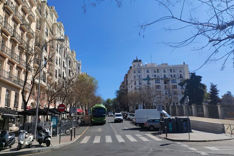 Photo of a street with buses and cars