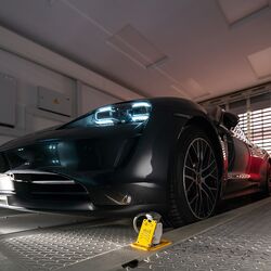 The car is positioned in an entry bay on a parking platform