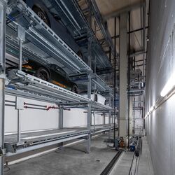 The car is parked in a shelving system