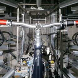 The bicycle is secured in a rail within the parking system
