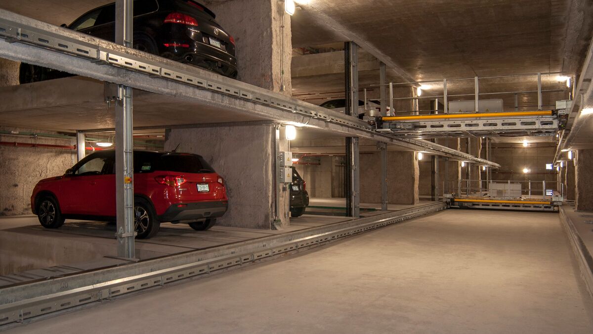 The car is parked on a parking pallet in a multi-storey car park system