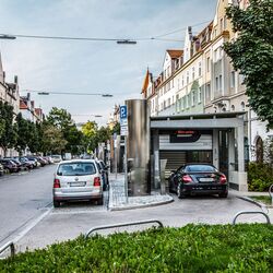 The car drives through an entrance gate