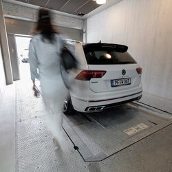 The car is parked in the entry bay of a parking system
