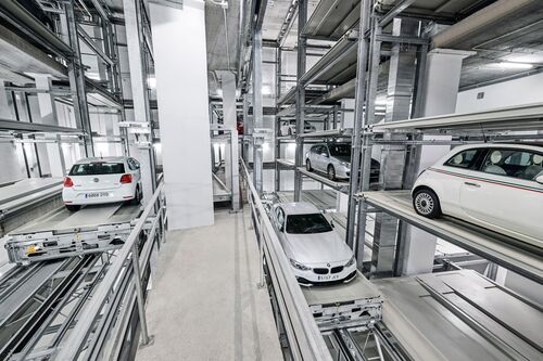 The cars are parked in a rack system