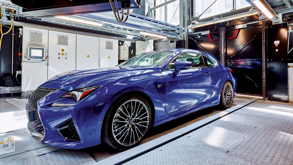 The car is positioned on a parking platform in an entry bay