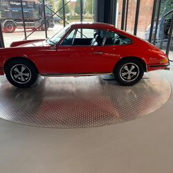 A red car is standing on a turntable