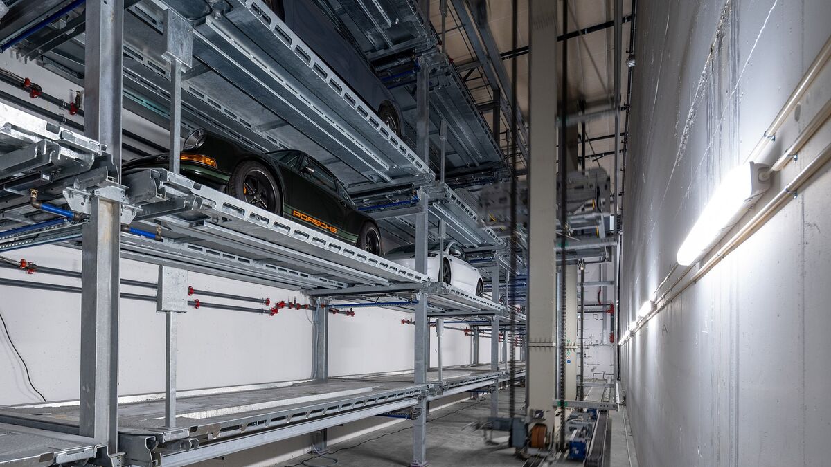 The car is parked in a shelving system