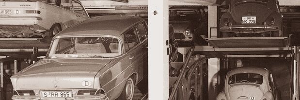 Two car parks filled with cars from 1962