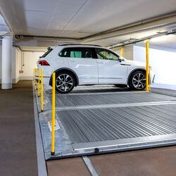 Parkplatte with a car parked on top of it in an underground car park
