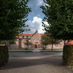 A historic building with trees in the foreground