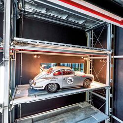 The car is parked in a shelving system