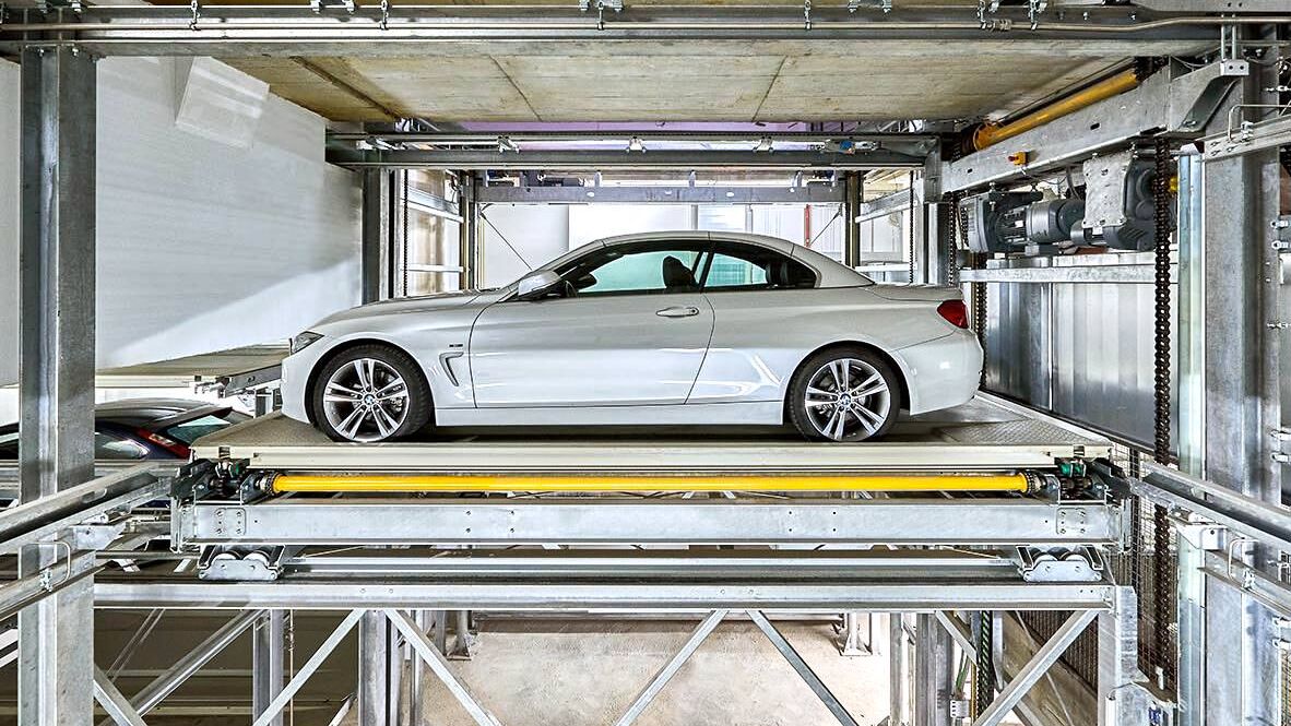 The car is parked on a parking platform in a multi-storey car park