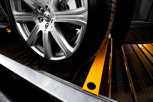 A car wheel on a parking plate