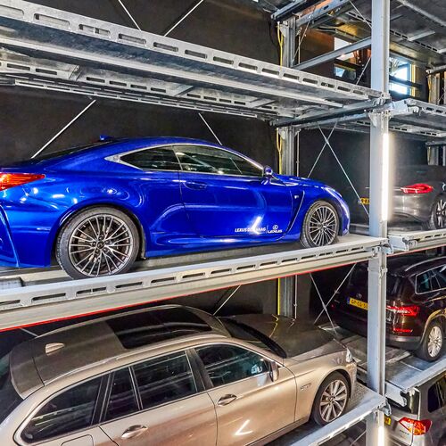 The car is parked on a parking pallet in a multi-storey car park system