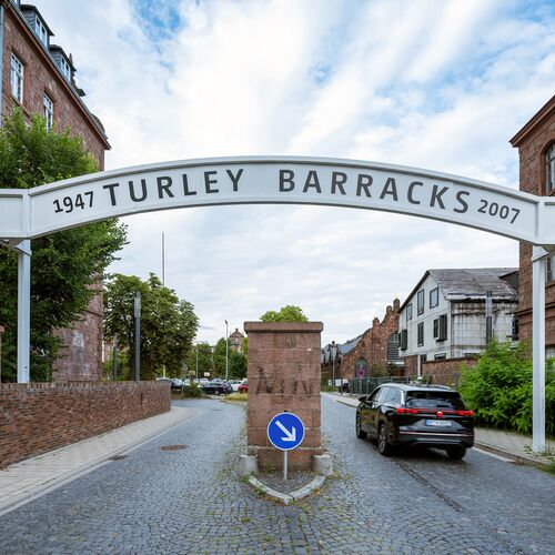 A car drives through an entrance gate