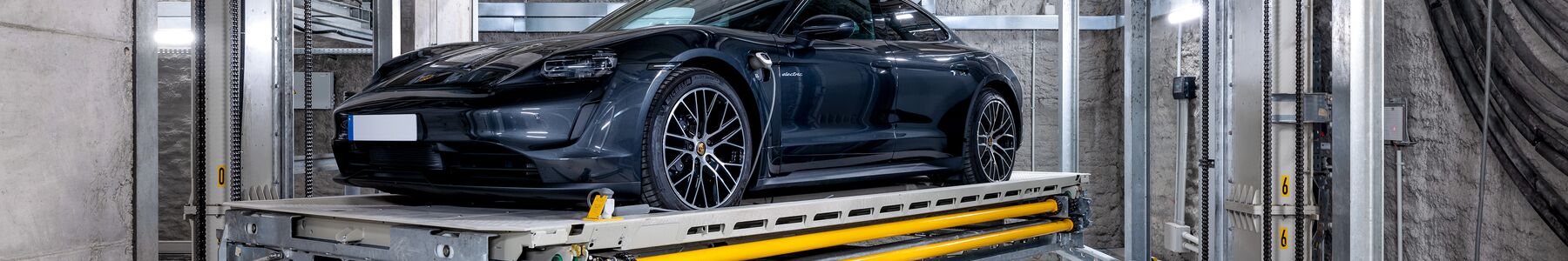 The car is parked on a platform in an underground parking system
