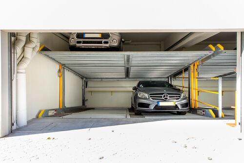 Two cars are parked in a parking system