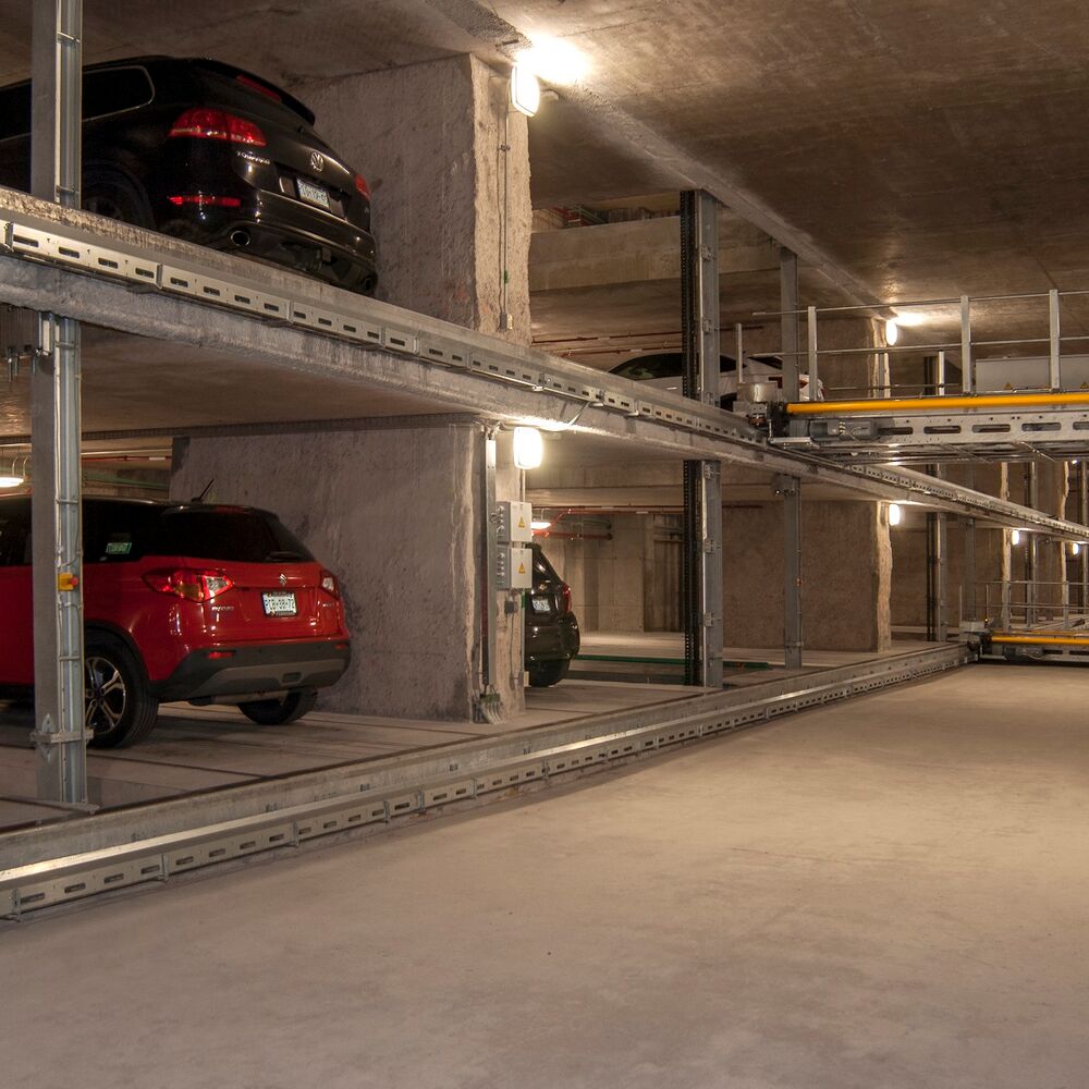 The car is parked on a parking pallet in a multi-storey car park system