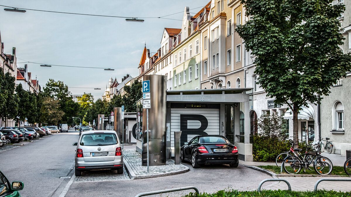 A car is parked in front of the entrance to the underground car park