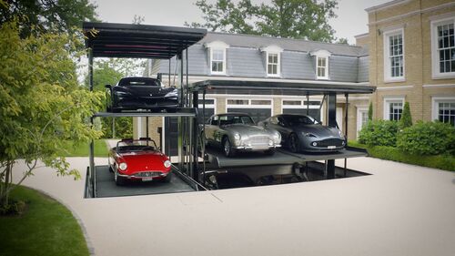 Parking system in a courtyard with cars stacked on top of one another