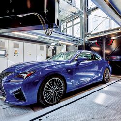 The car is positioned on a parking platform in an entry bay
