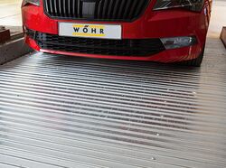 The car is parked on a parking slab