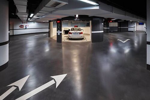 The car is parked in an entry bay on a parking platform